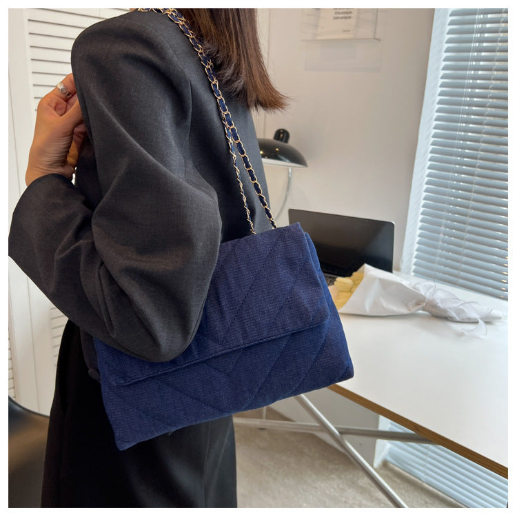 Elevate your style with this fashion luxury denim blue shoulder bag for women. Designed as a briefcase, this handbag is a chic and stylish accessory for a sophisticated and classy look. -
