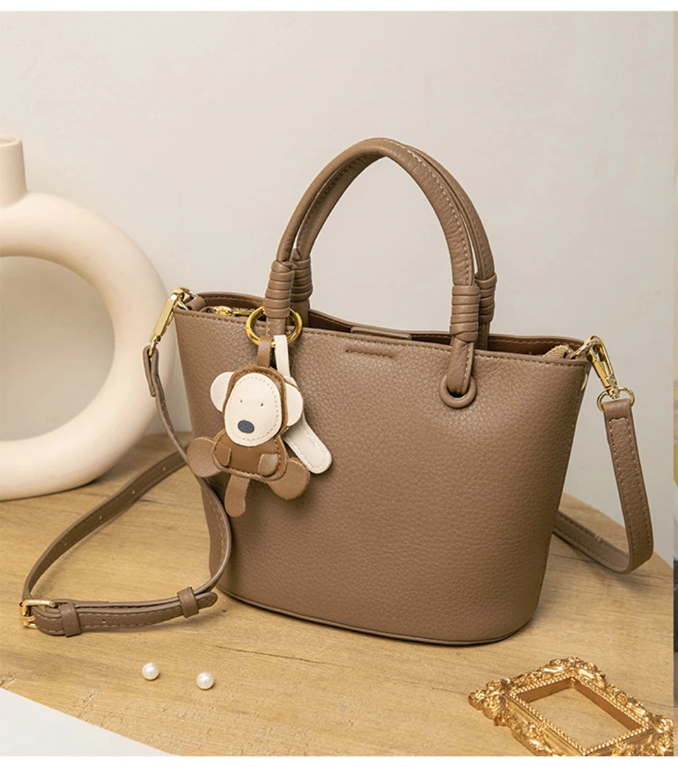 Upgrade your accessories with this new bucket bag for women. Featuring a fashionable and versatile design, this handheld bag is perfect for adding a chic and trendy touch to your look. -