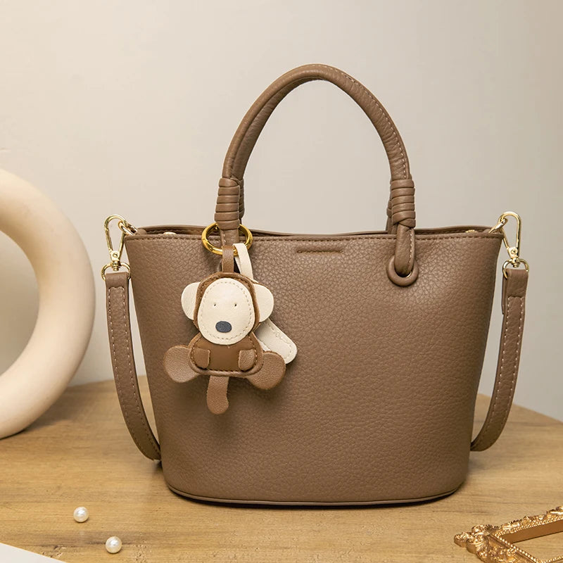 Upgrade your accessories with this new bucket bag for women. Featuring a fashionable and versatile design, this handheld bag is perfect for adding a chic and trendy touch to your look. -