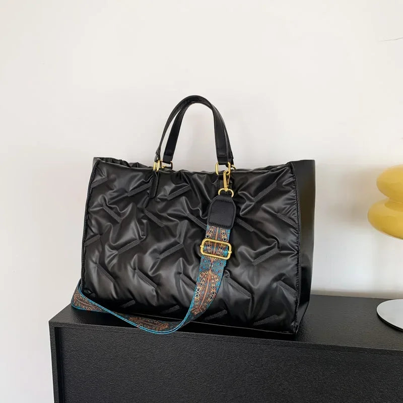 Stay on-trend with this fashion-forward large tote padded handbag featuring a designer quilted design. This stylish accessory is perfect for adding a touch of sophistication and elegance to your ensemble. -
