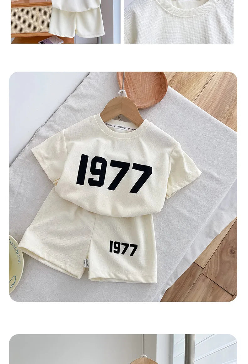 Dress your little athletes in style with this trendy two-piece set—featuring printed short-sleeve tops and shorts for both boys and girls! -