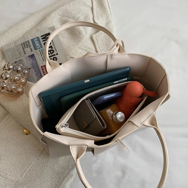 Make a fashion statement with this large capacity handbag. Crafted with stylish woven leather, this tote bag is perfect for adding a touch of elegance to your everyday outfit. -