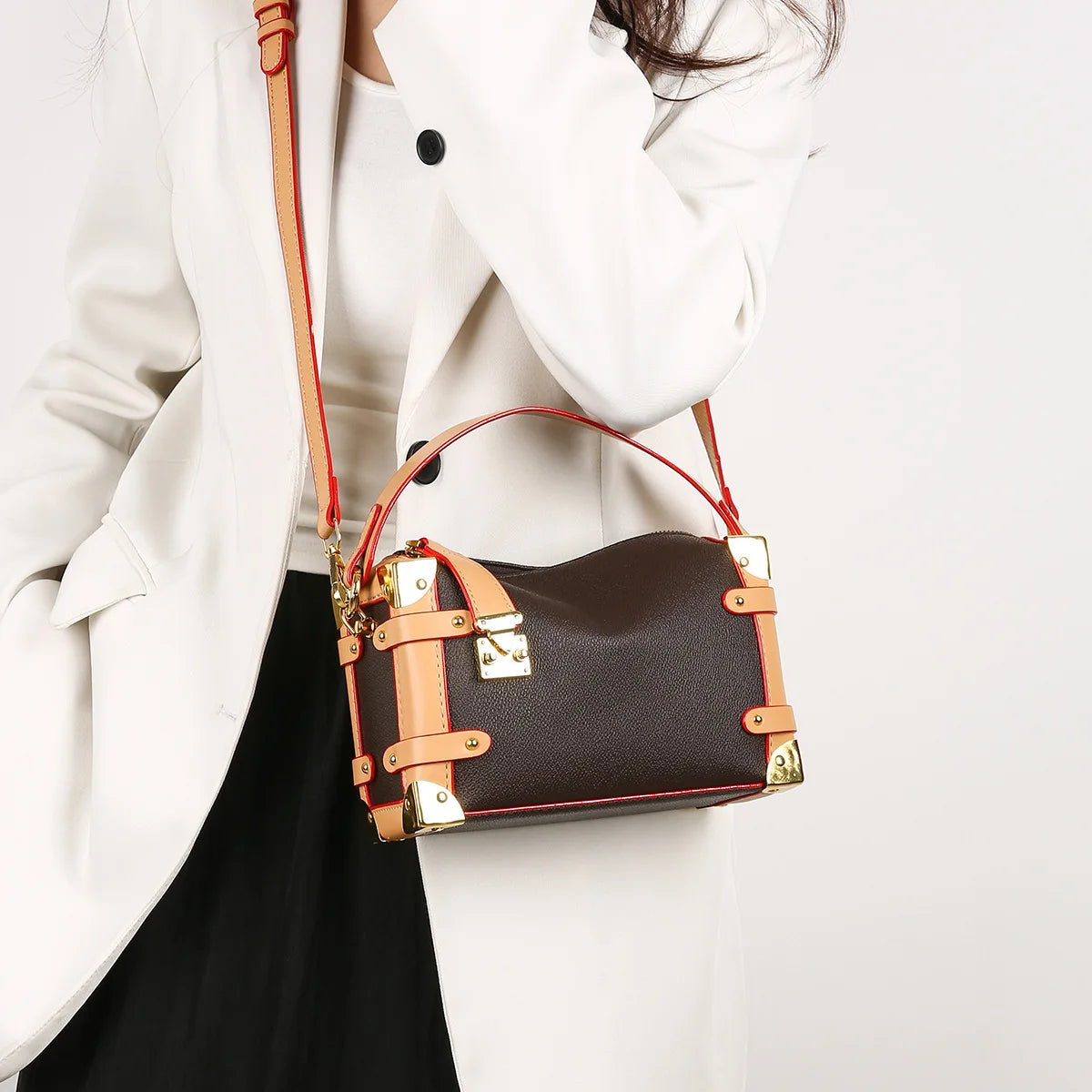 Make a statement with this luxurious and elegant box bag for women. Crafted from high-quality leather, this shoulder handbag features an elegant top-handle design, exuding sophistication and style for a classy finishing touch to your ensemble. -