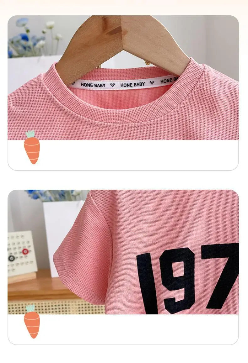 Dress your little athletes in style with this trendy two-piece set—featuring printed short-sleeve tops and shorts for both boys and girls! -