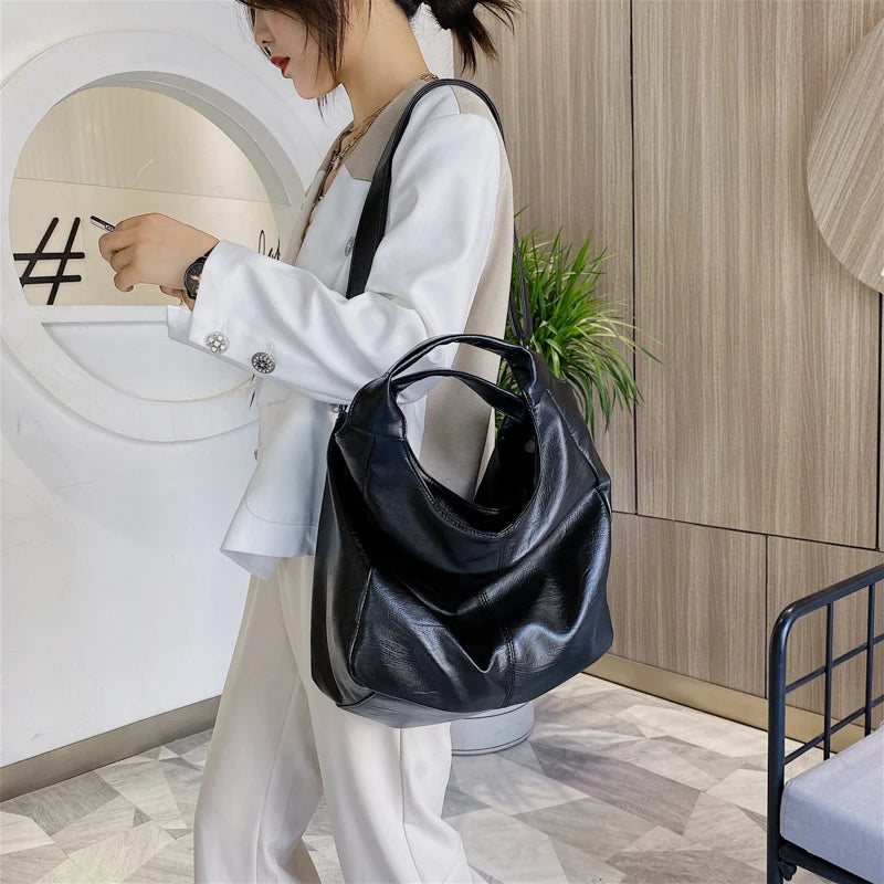 Make a stylish statement with these large shoulder bags designed for women. Crafted from soft leather, these fashionable handbags are perfect for adding a touch of sophistication to any outfit. -
