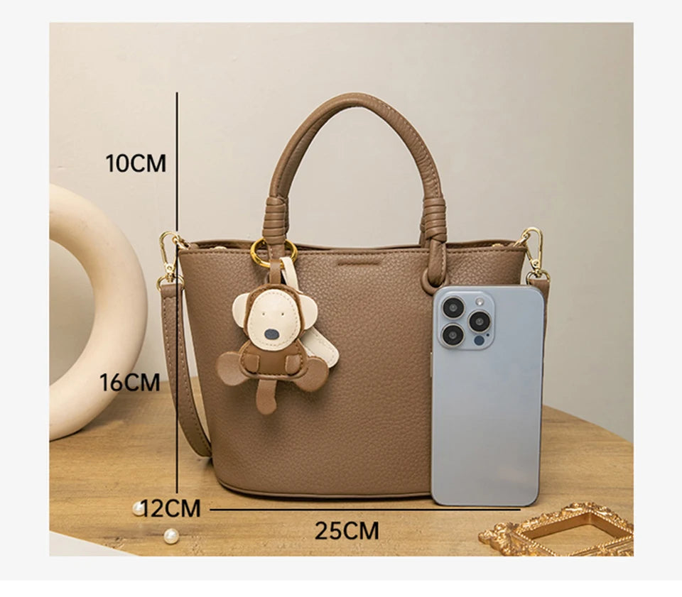 Upgrade your accessories with this new bucket bag for women. Featuring a fashionable and versatile design, this handheld bag is perfect for adding a chic and trendy touch to your look. -