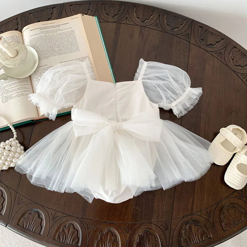 Dress your toddler in sweet style with this new baby lace dress featuring a big bowknot and short sleeves—perfect for special occasions! -