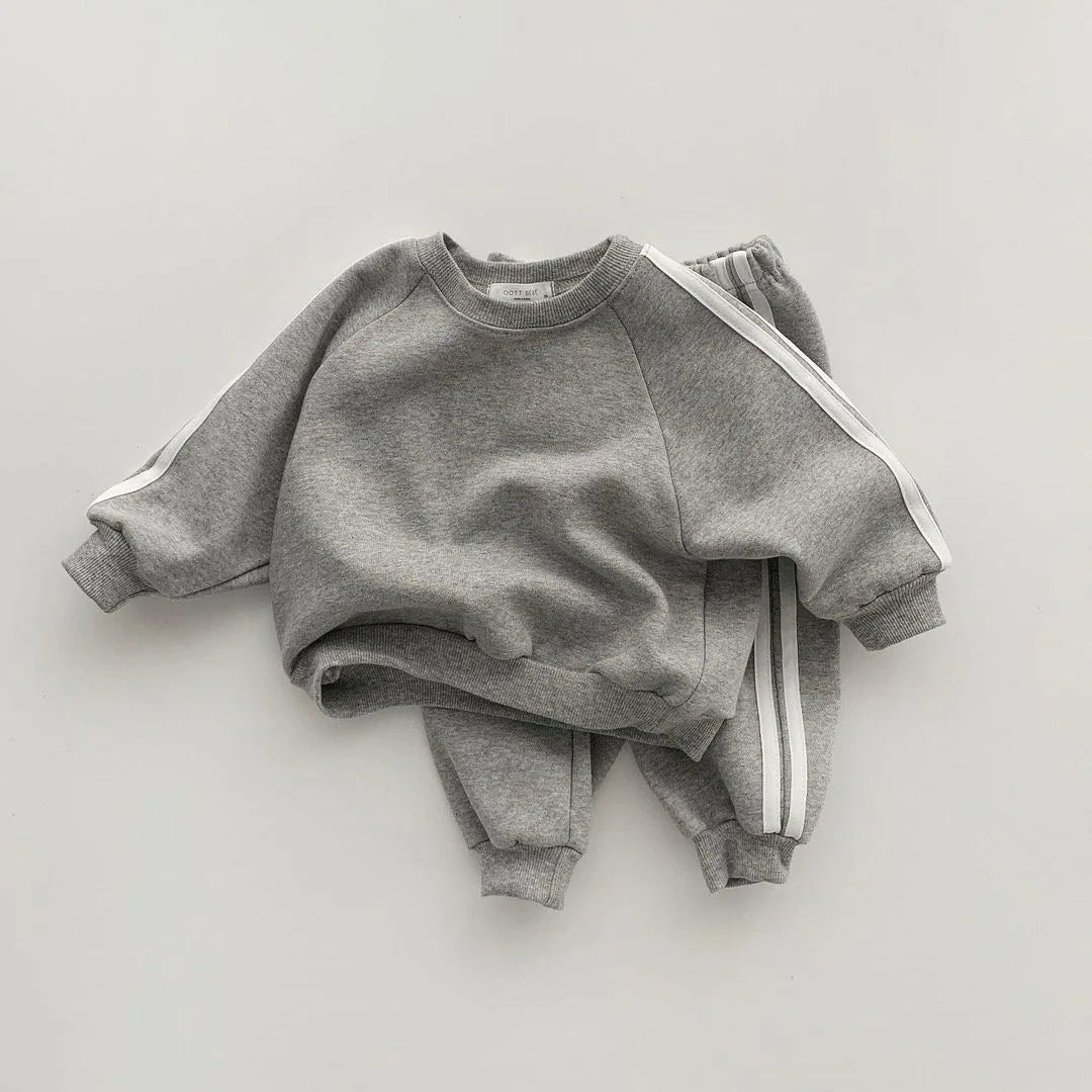 Keep your little one stylish and comfy with this cool two-piece baby suit—featuring a letter-printed zip-up top and matching leisure sports pants! -