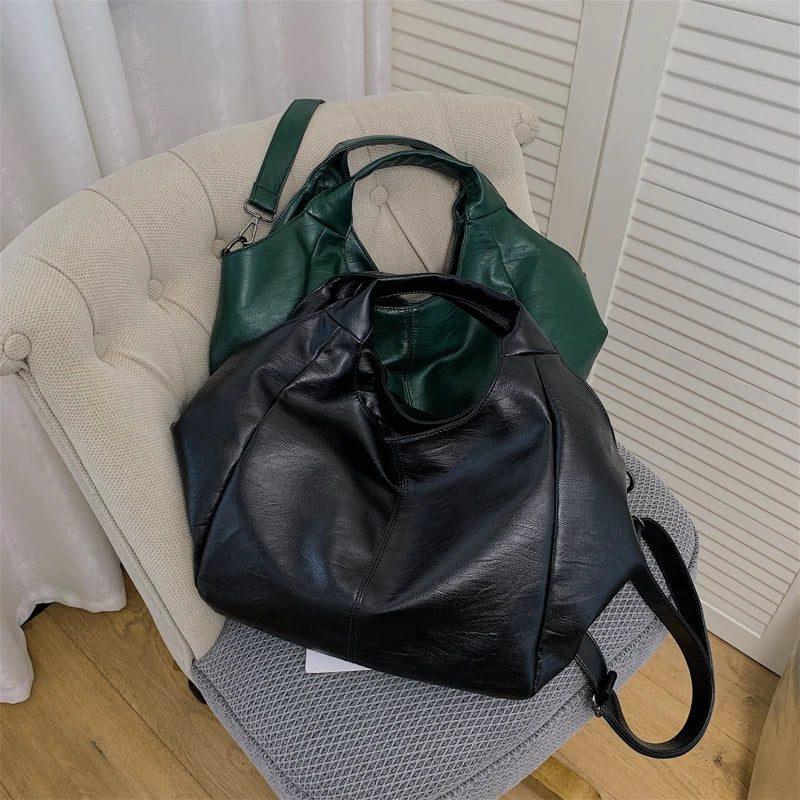 Make a stylish statement with these large shoulder bags designed for women. Crafted from soft leather, these fashionable handbags are perfect for adding a touch of sophistication to any outfit. -