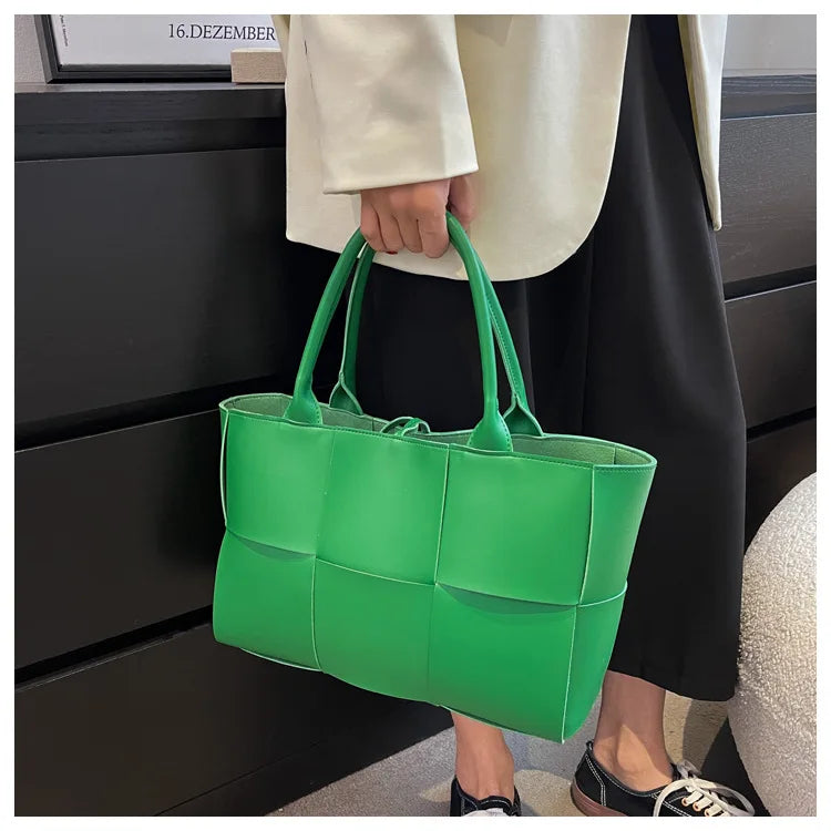 Make a fashion statement with this large capacity handbag. Crafted with stylish woven leather, this tote bag is perfect for adding a touch of elegance to your everyday outfit. -