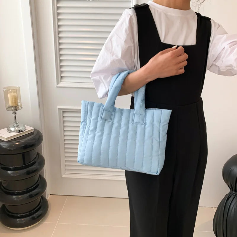Carry your essentials in style with this large capacity and cotton-padded tote bag designed for ladies. Featuring a solid color and casual fashion, this bag is both practical and fashionable for everyday use. -