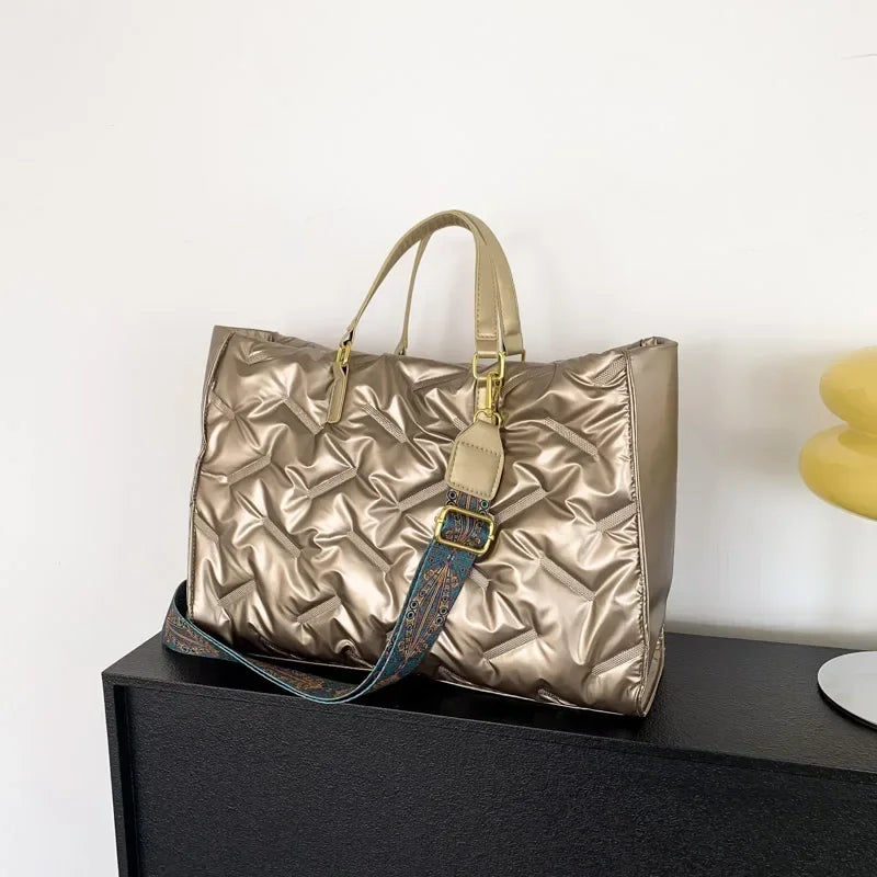 Stay on-trend with this fashion-forward large tote padded handbag featuring a designer quilted design. This stylish accessory is perfect for adding a touch of sophistication and elegance to your ensemble. -
