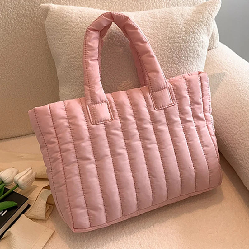 Carry your essentials in style with this large capacity and cotton-padded tote bag designed for ladies. Featuring a solid color and casual fashion, this bag is both practical and fashionable for everyday use. -