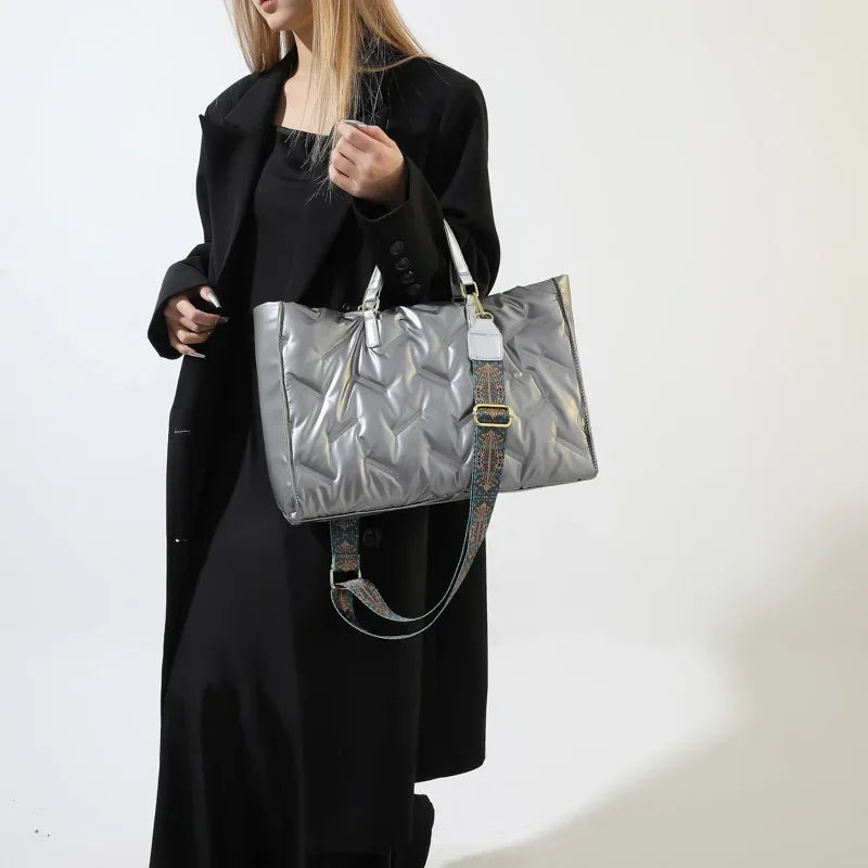Stay on-trend with this fashion-forward large tote padded handbag featuring a designer quilted design. This stylish accessory is perfect for adding a touch of sophistication and elegance to your ensemble. -