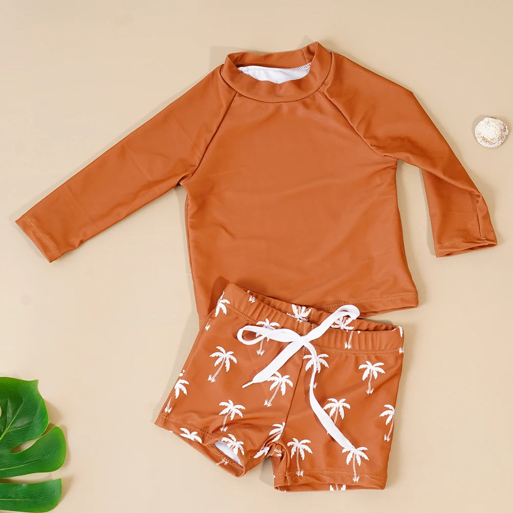 Make a splash in style with this fashionable and cute long-sleeve swimsuit for baby boys and girls—perfect for pool days and swim fun! -