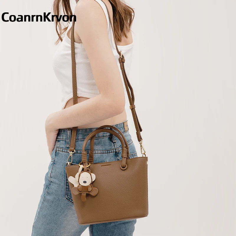 Upgrade your accessories with this new bucket bag for women. Featuring a fashionable and versatile design, this handheld bag is perfect for adding a chic and trendy touch to your look. -