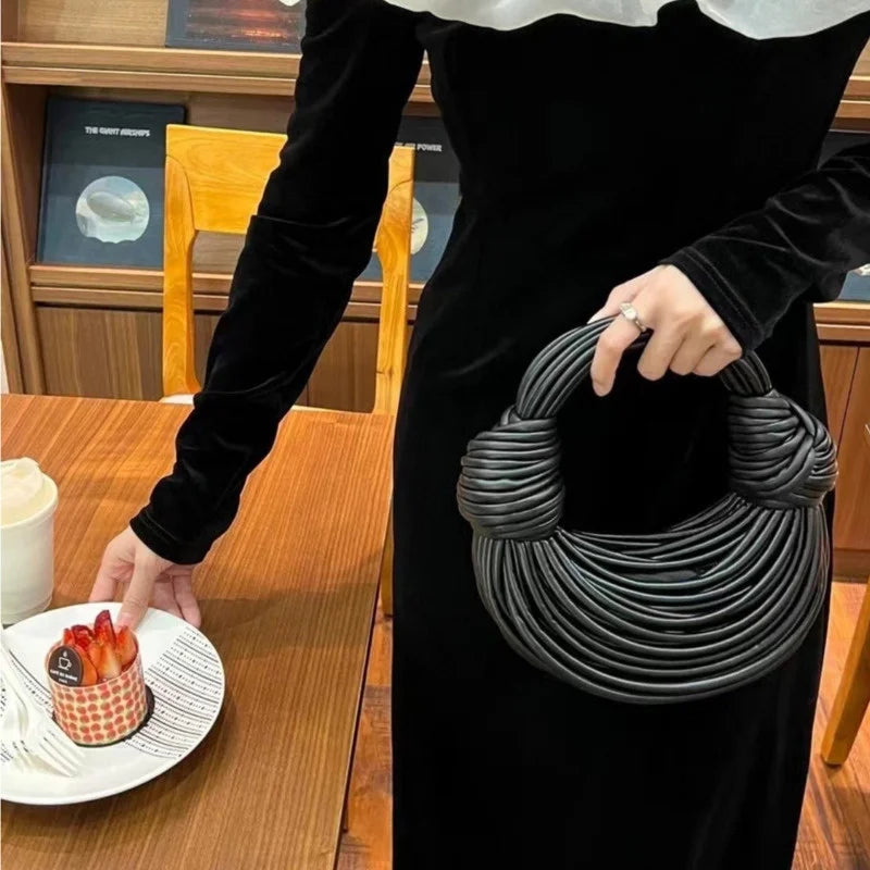 Make a statement with this gold luxury designer brand handwoven noodle bag. With a rope-knotted hobo design and a chic silver evening clutch, this bag is the epitome of high fashion and sophistication. -