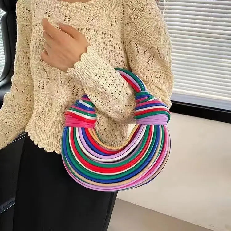 Make a statement with this gold luxury designer brand handwoven noodle bag. With a rope-knotted hobo design and a chic silver evening clutch, this bag is the epitome of high fashion and sophistication. -
