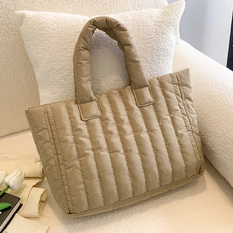 Carry your essentials in style with this large capacity and cotton-padded tote bag designed for ladies. Featuring a solid color and casual fashion, this bag is both practical and fashionable for everyday use. -