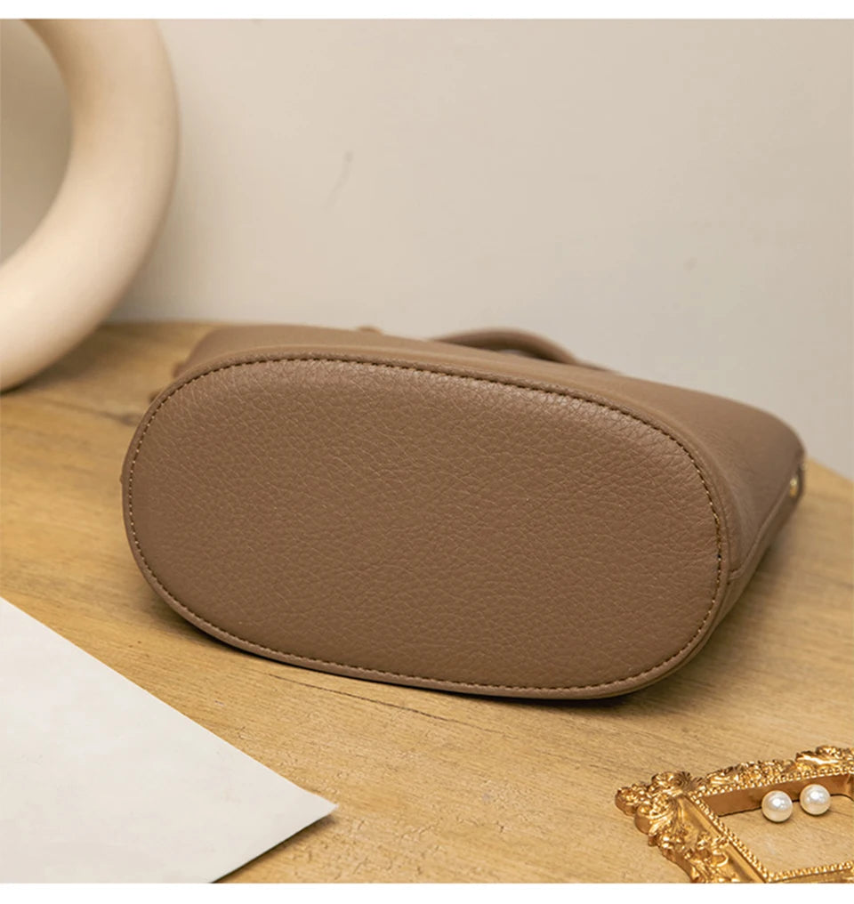 Upgrade your accessories with this new bucket bag for women. Featuring a fashionable and versatile design, this handheld bag is perfect for adding a chic and trendy touch to your look. -