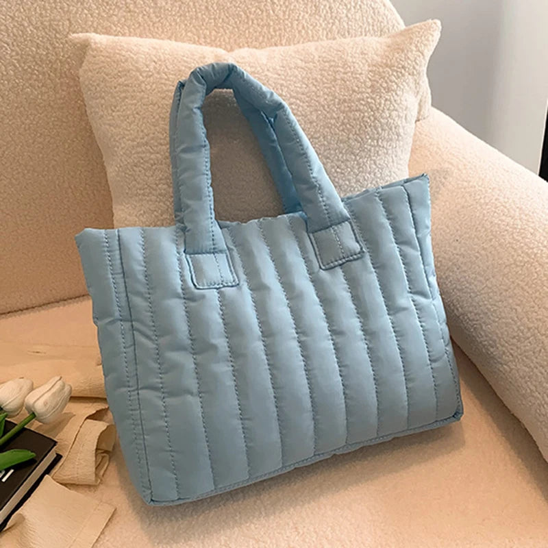 Carry your essentials in style with this large capacity and cotton-padded tote bag designed for ladies. Featuring a solid color and casual fashion, this bag is both practical and fashionable for everyday use. -
