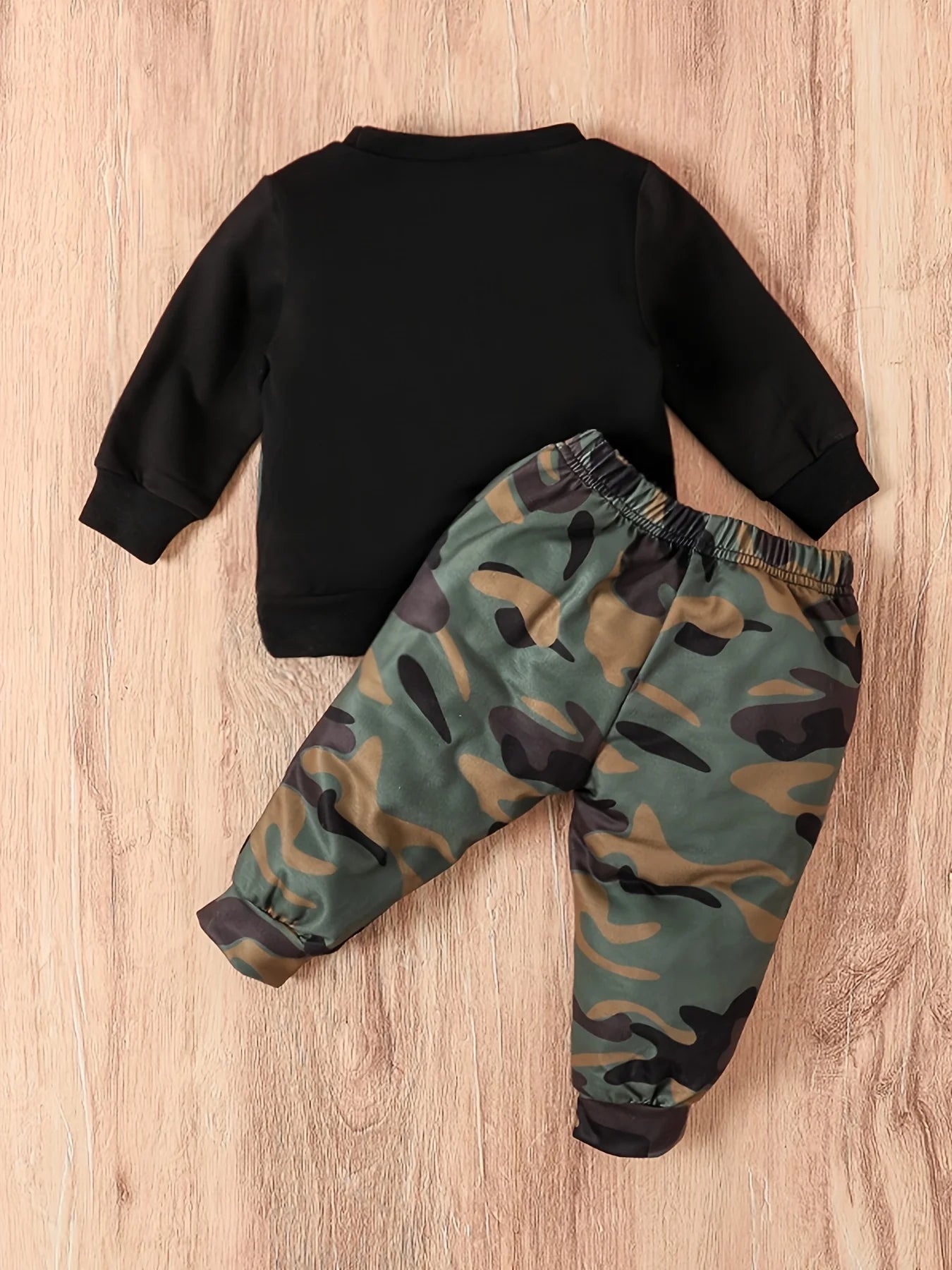 Dress your little guy sharp and comfy with this two-piece baby boy set—long-sleeved round neck top paired with stylish camouflage pants! -