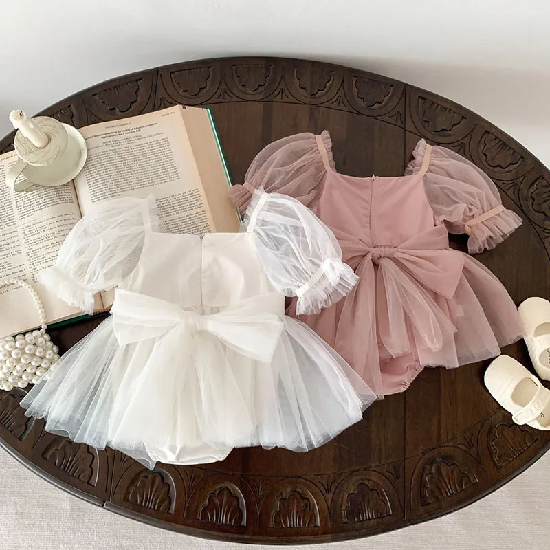 Dress your toddler in sweet style with this new baby lace dress featuring a big bowknot and short sleeves—perfect for special occasions! -