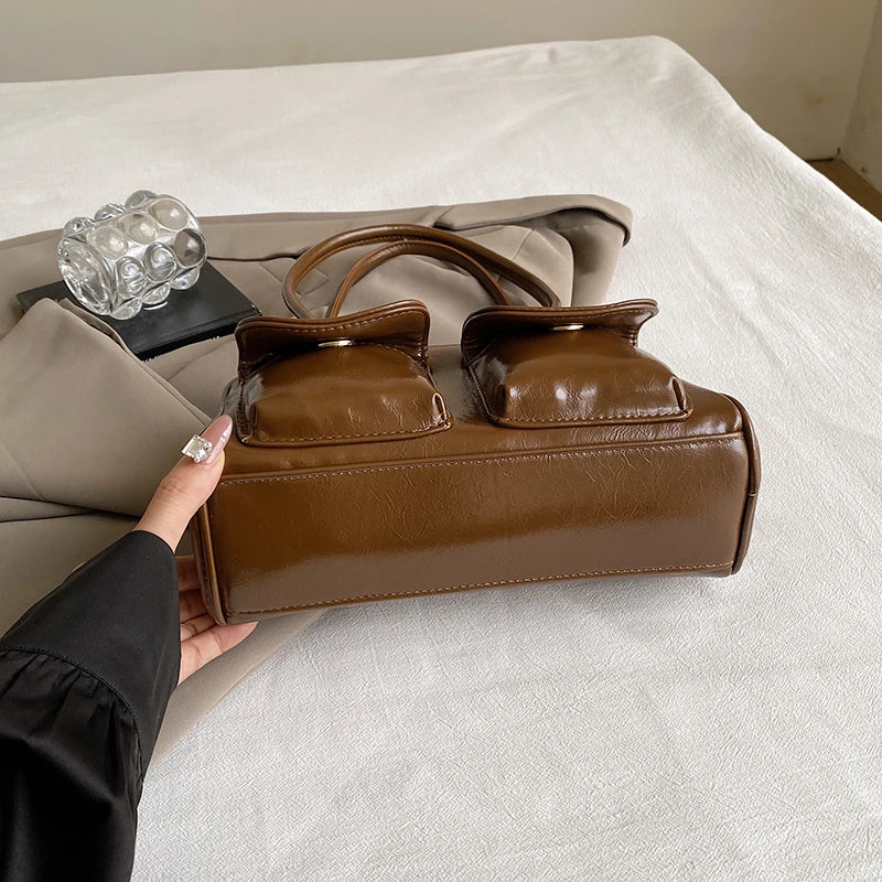 Accessorize stylishly with this black shoulder bag for women. This versatile handbag can be carried as a purse or a crossbody bag, making it a chic and practical choice for all occasions. -