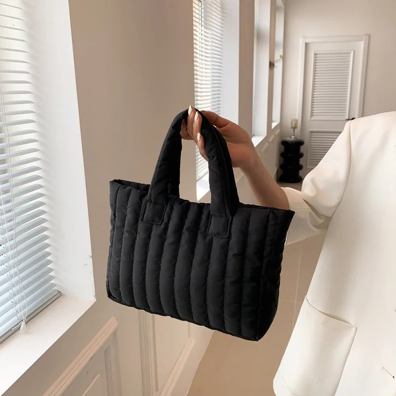 Carry your essentials in style with this large capacity and cotton-padded tote bag designed for ladies. Featuring a solid color and casual fashion, this bag is both practical and fashionable for everyday use. -