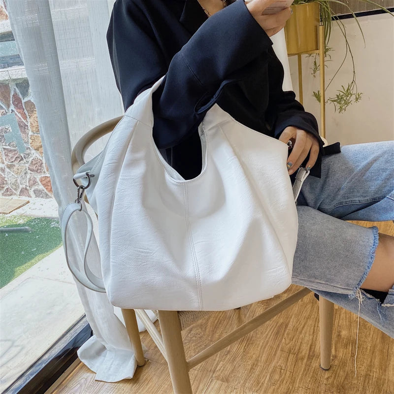 Make a stylish statement with these large shoulder bags designed for women. Crafted from soft leather, these fashionable handbags are perfect for adding a touch of sophistication to any outfit. -