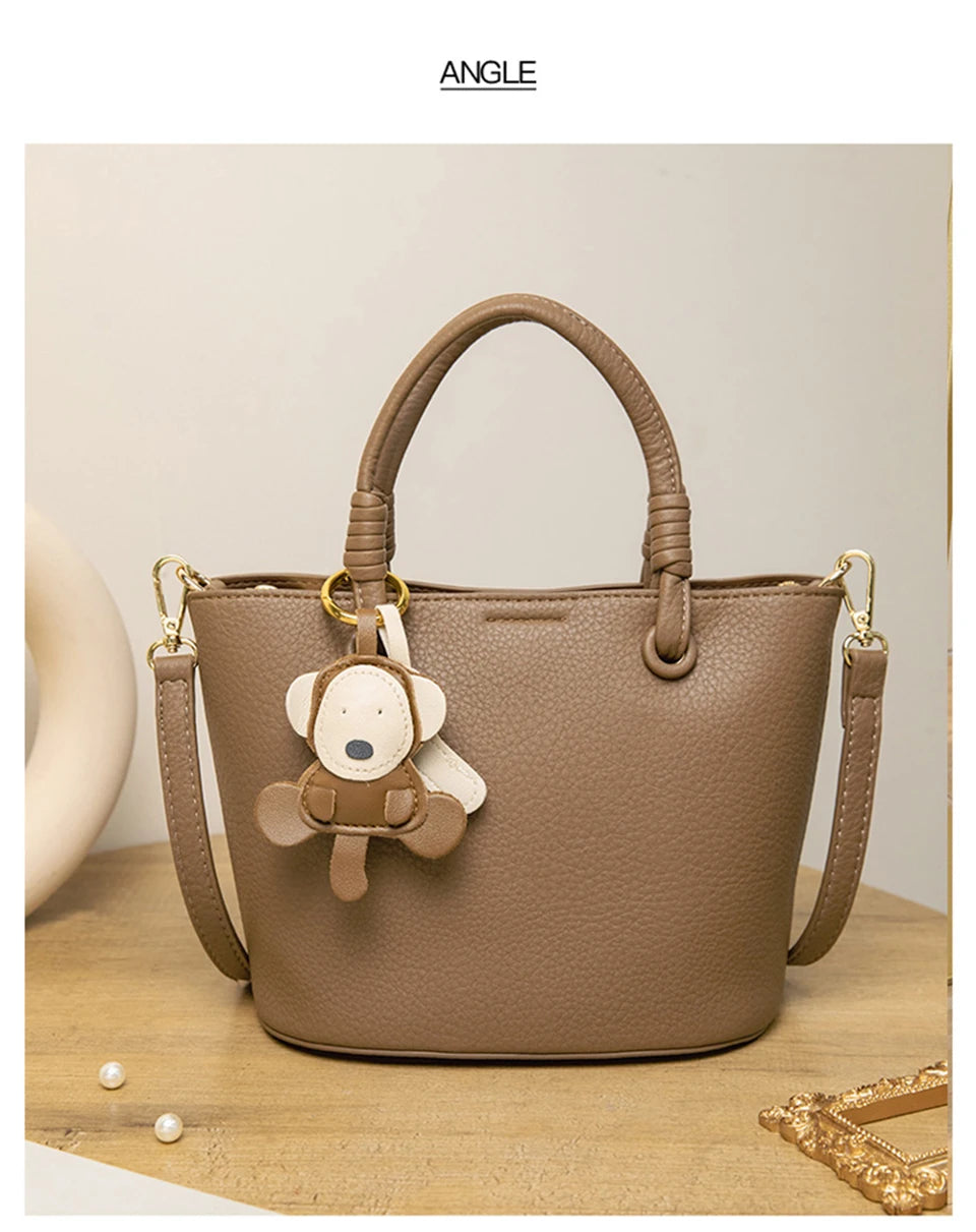 Upgrade your accessories with this new bucket bag for women. Featuring a fashionable and versatile design, this handheld bag is perfect for adding a chic and trendy touch to your look. -