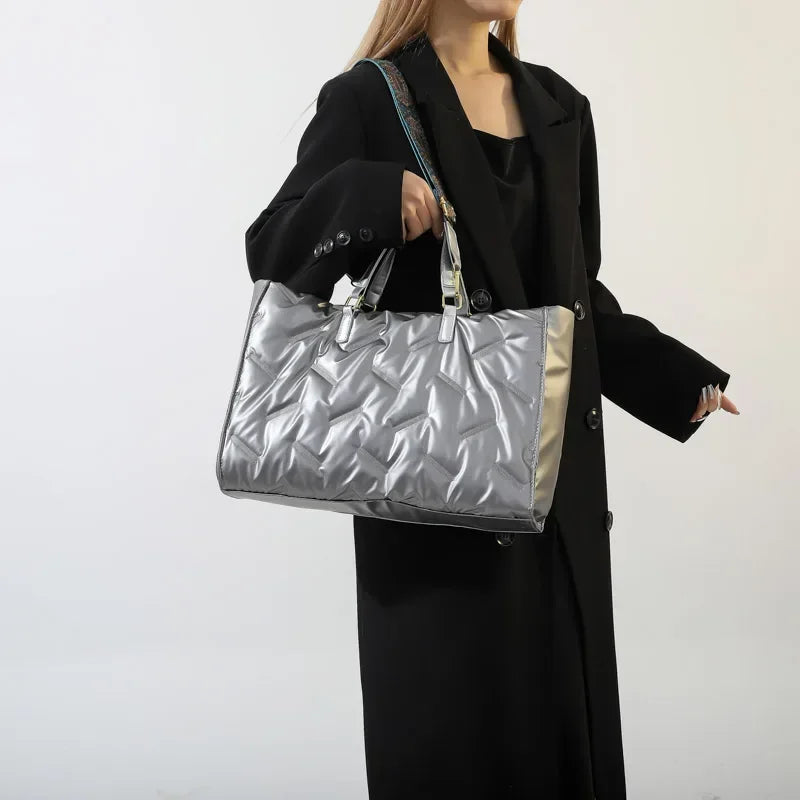 Stay on-trend with this fashion-forward large tote padded handbag featuring a designer quilted design. This stylish accessory is perfect for adding a touch of sophistication and elegance to your ensemble. -