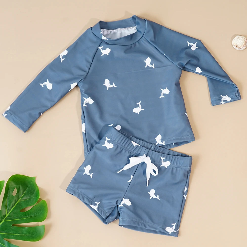 Make a splash in style with this fashionable and cute long-sleeve swimsuit for baby boys and girls—perfect for pool days and swim fun! -