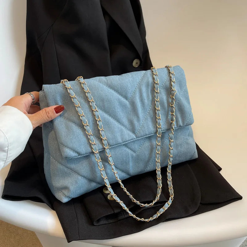 Elevate your style with this fashion luxury denim blue shoulder bag for women. Designed as a briefcase, this handbag is a chic and stylish accessory for a sophisticated and classy look. -