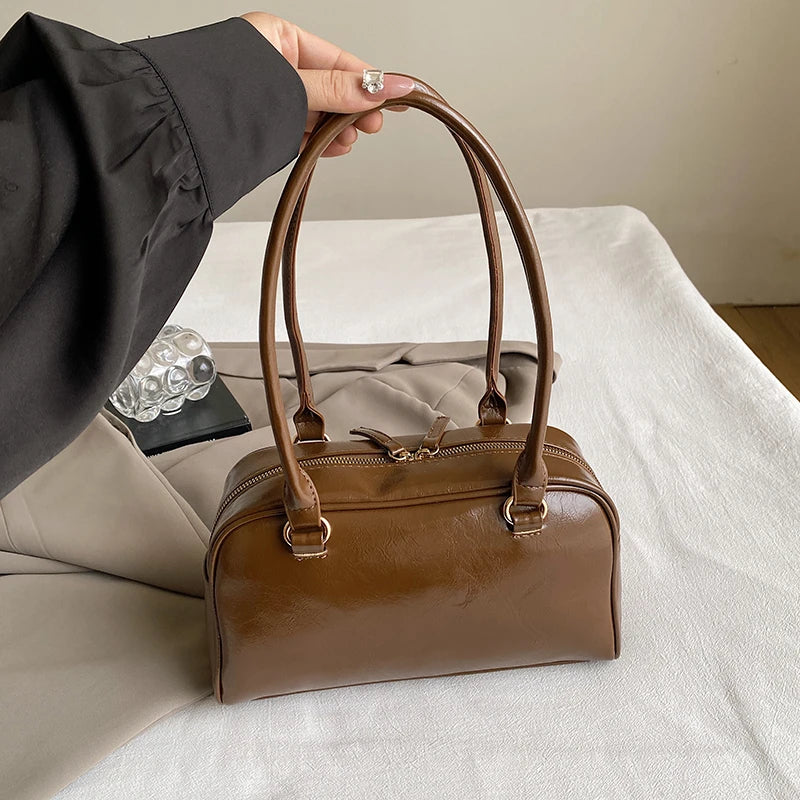 Accessorize stylishly with this black shoulder bag for women. This versatile handbag can be carried as a purse or a crossbody bag, making it a chic and practical choice for all occasions. -