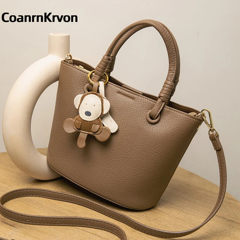 Upgrade your accessories with this new bucket bag for women. Featuring a fashionable and versatile design, this handheld bag is perfect for adding a chic and trendy touch to your look. -