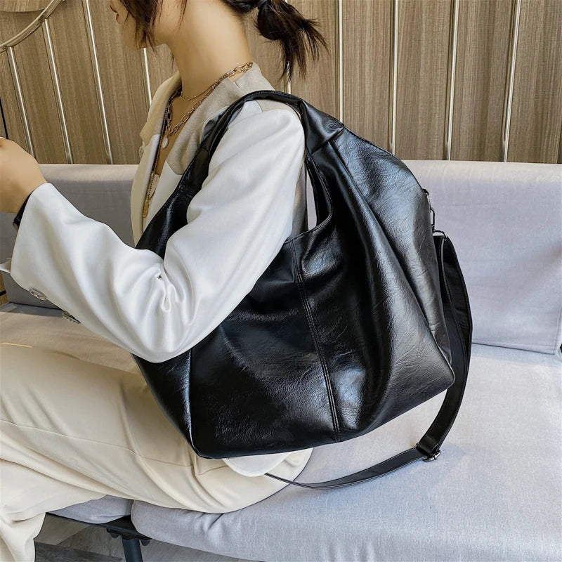 Make a stylish statement with these large shoulder bags designed for women. Crafted from soft leather, these fashionable handbags are perfect for adding a touch of sophistication to any outfit. -