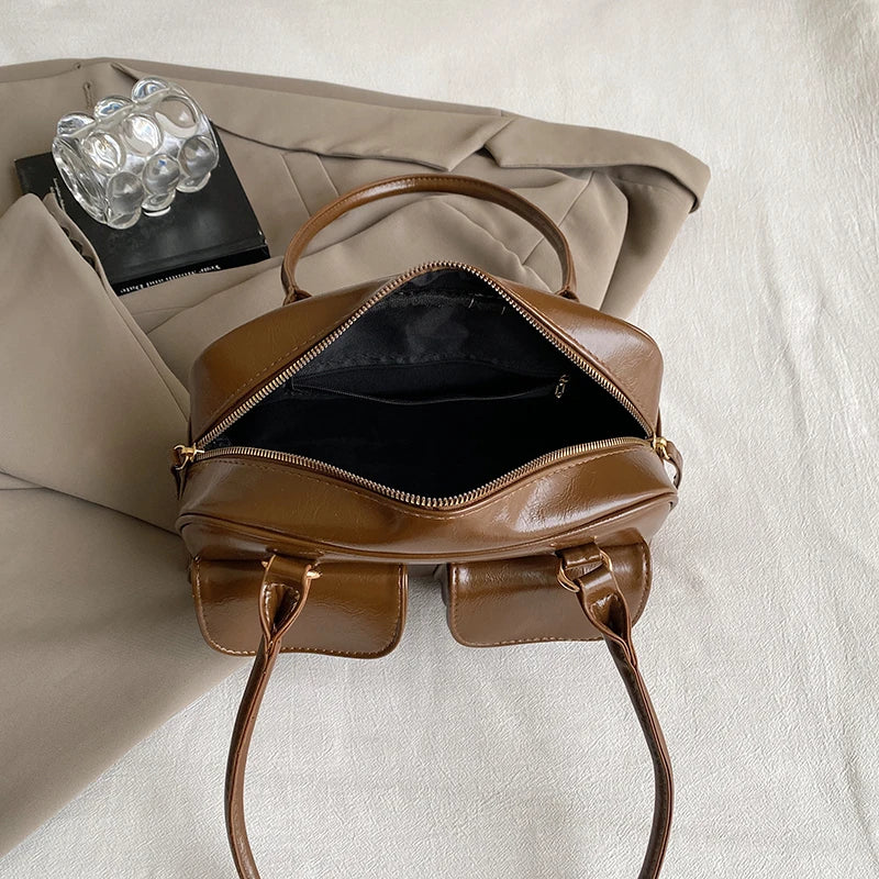 Accessorize stylishly with this black shoulder bag for women. This versatile handbag can be carried as a purse or a crossbody bag, making it a chic and practical choice for all occasions. -