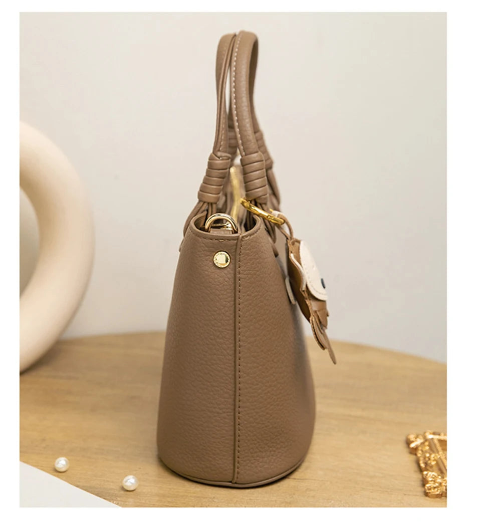 Upgrade your accessories with this new bucket bag for women. Featuring a fashionable and versatile design, this handheld bag is perfect for adding a chic and trendy touch to your look. -