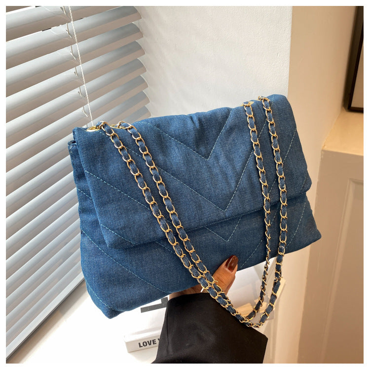 Elevate your style with this fashion luxury denim blue shoulder bag for women. Designed as a briefcase, this handbag is a chic and stylish accessory for a sophisticated and classy look. -