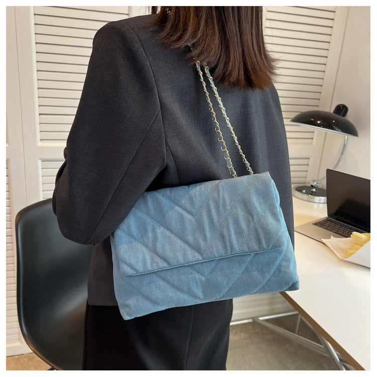 Elevate your style with this fashion luxury denim blue shoulder bag for women. Designed as a briefcase, this handbag is a chic and stylish accessory for a sophisticated and classy look. -