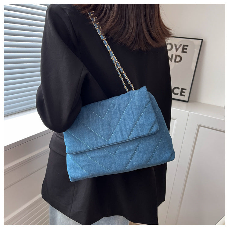 Elevate your style with this fashion luxury denim blue shoulder bag for women. Designed as a briefcase, this handbag is a chic and stylish accessory for a sophisticated and classy look. -
