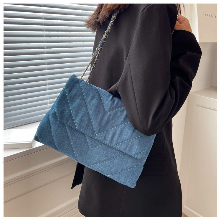 Elevate your style with this fashion luxury denim blue shoulder bag for women. Designed as a briefcase, this handbag is a chic and stylish accessory for a sophisticated and classy look. -