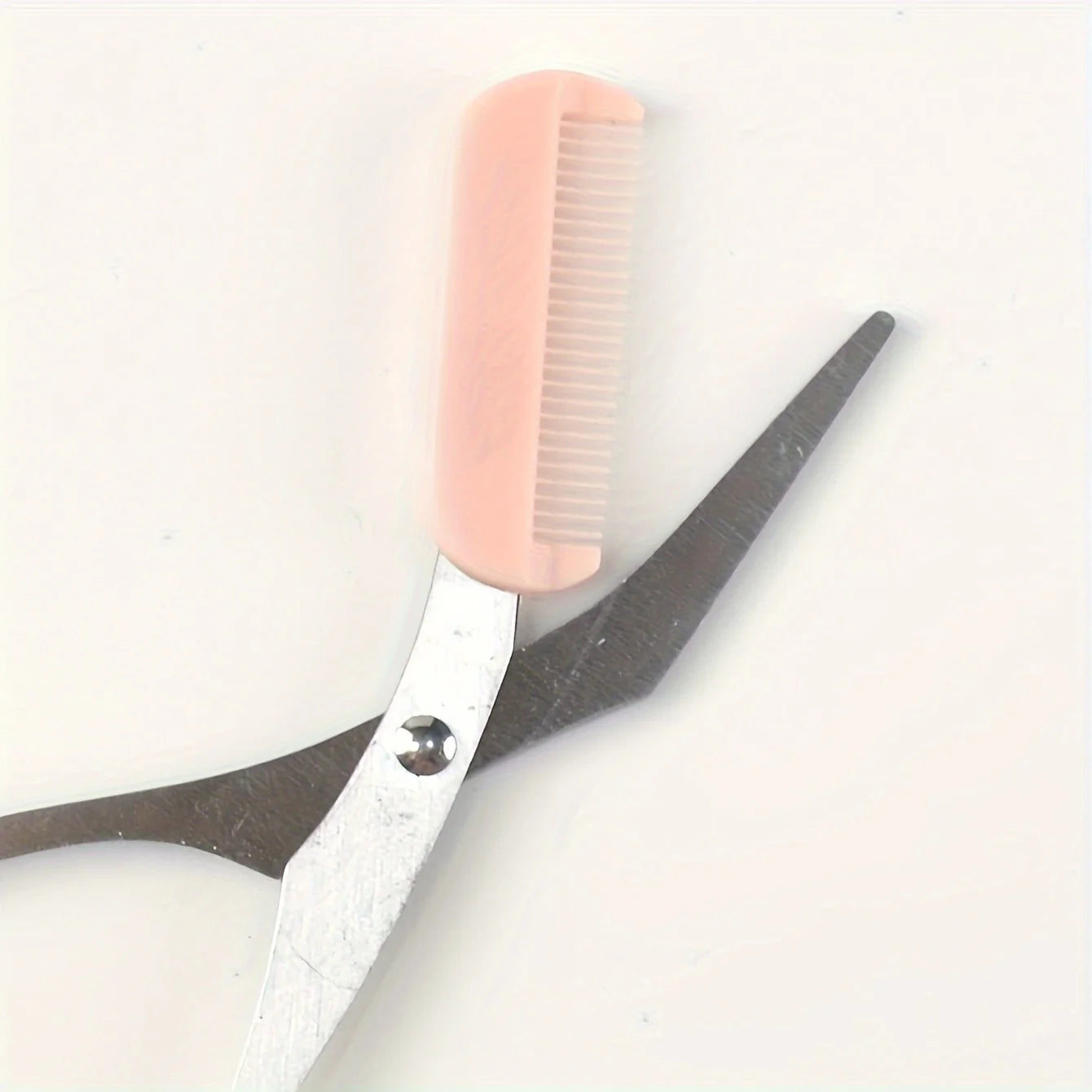 Eyebrow trimming scissors with built-in comb -