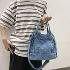 Elevate your casual look with this denim shoulder bag for women. Featuring a large design and zipper closure, this bag is perfect for shopping and everyday use, adding a touch of style to your outfit. -
