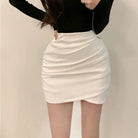 Turn heads with this girl's high-waist slim-fit short skirt featuring an irregular pleated hip design—sexy, versatile, and perfect for juniors! -