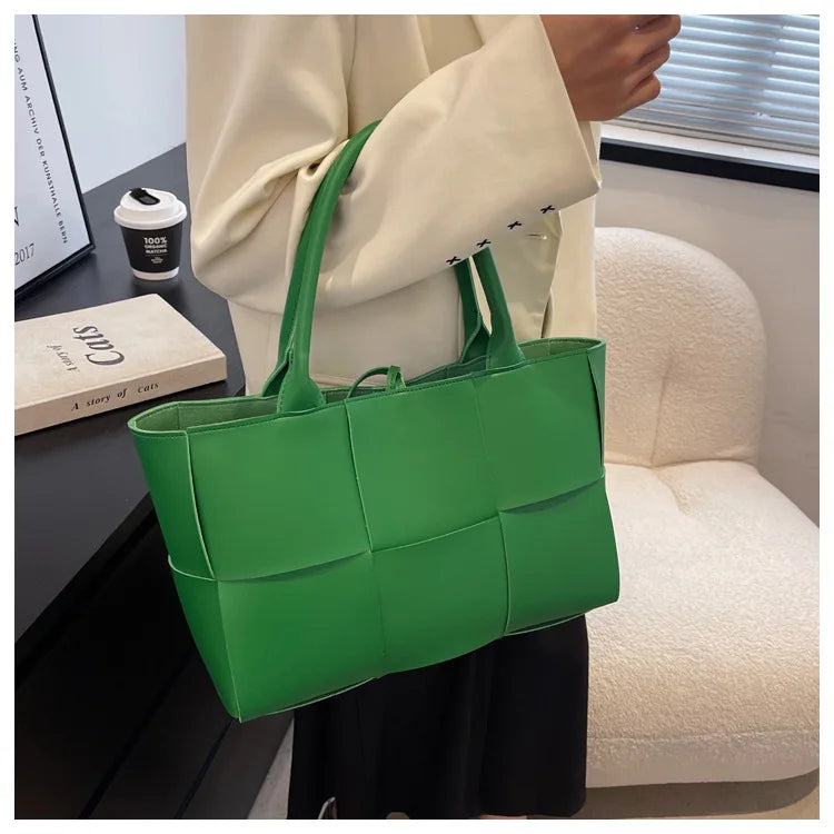 Make a fashion statement with this large capacity handbag. Crafted with stylish woven leather, this tote bag is perfect for adding a touch of elegance to your everyday outfit. -