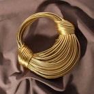 Make a statement with this gold luxury designer brand handwoven noodle bag. With a rope-knotted hobo design and a chic silver evening clutch, this bag is the epitome of high fashion and sophistication. -