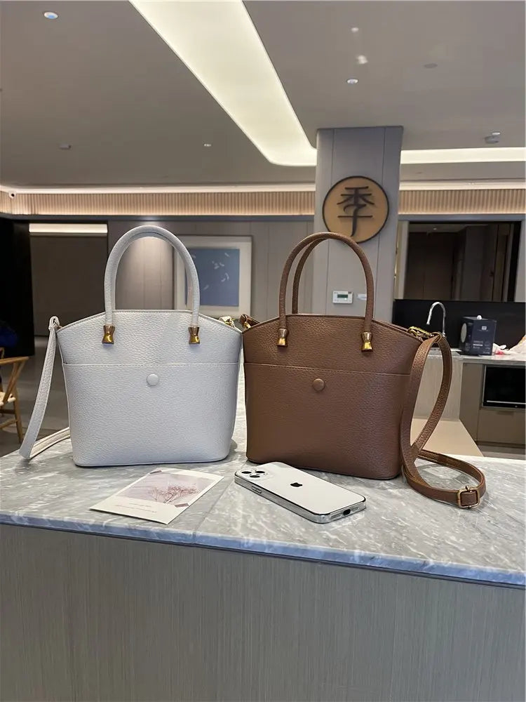 Elevate your style with this elegant tote bag. Crafted from genuine leather, this bag exudes sophistication and is the perfect accessory for a chic and classy look. -