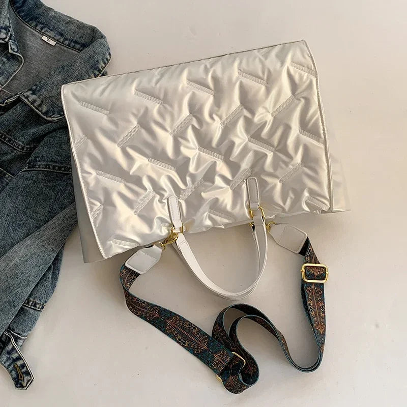 Stay on-trend with this fashion-forward large tote padded handbag featuring a designer quilted design. This stylish accessory is perfect for adding a touch of sophistication and elegance to your ensemble. -